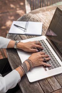 Woman typing on a laptop's keyboard